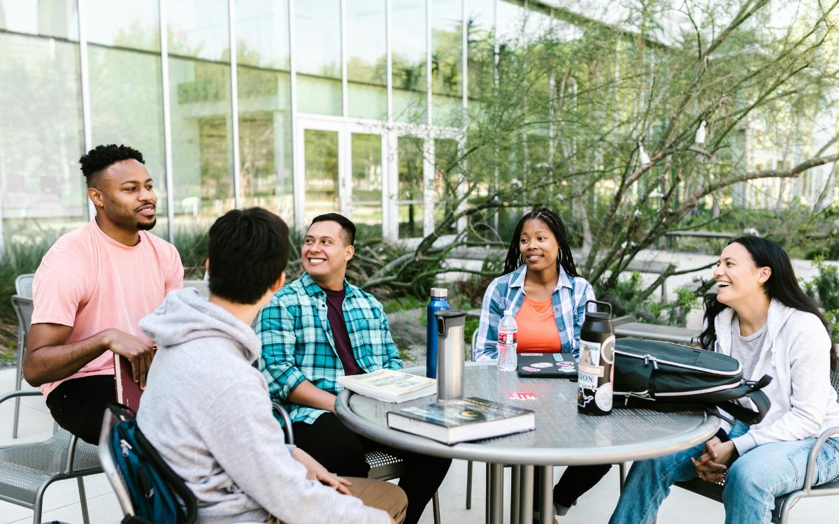 Group of students sitting in a courtyard talking