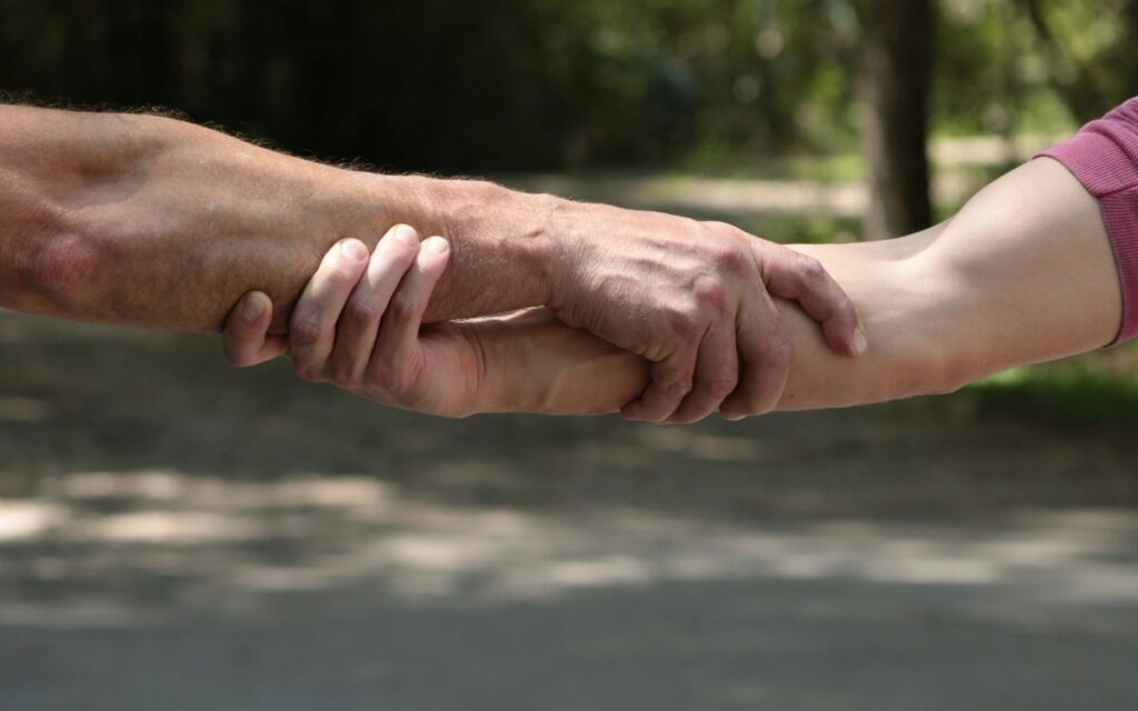 Two hands grasping each other