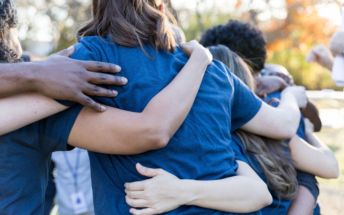 a group of young adults hugging